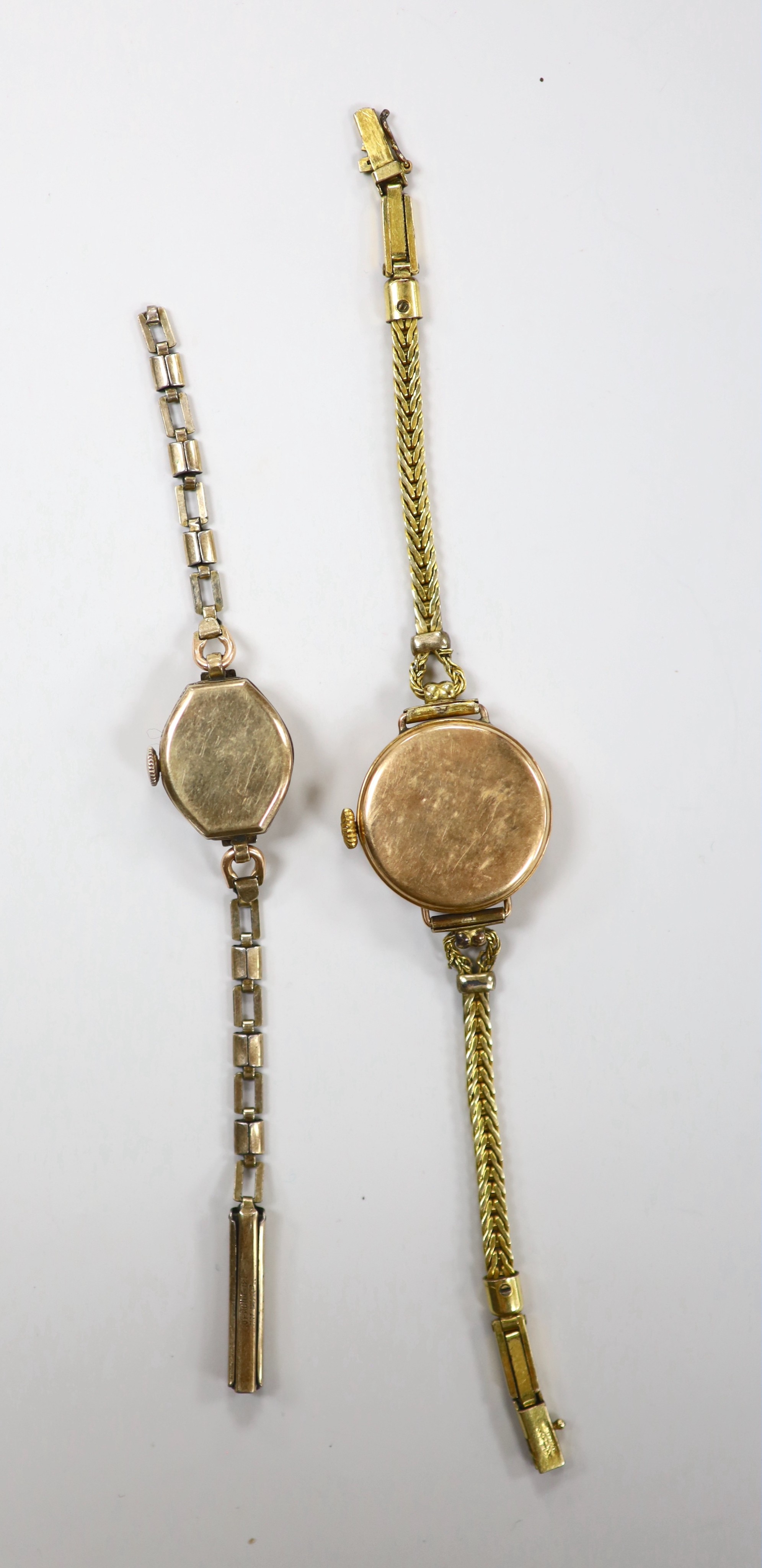 A lady's early 20th century 9ct gold manual wind wrist watch, on a gold plated bracelet and a lady's 10k gold filled Monarch manual wind wrist watch, on gold plated bracelet.